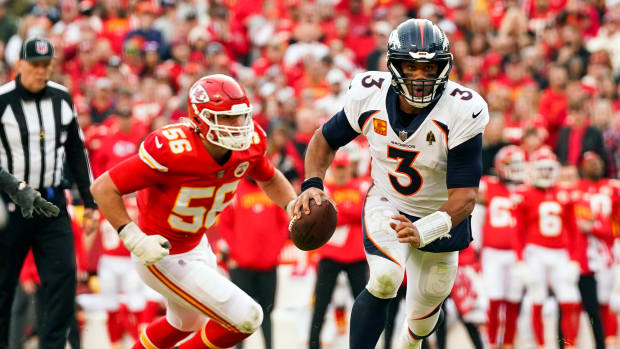 Jan 1, 2023; Kansas City, Missouri, USA; Denver Broncos quarterback Russell Wilson (3) runs for a touchdown past Kansas City Chiefs defensive end George Karlaftis (56) during the second half at GEHA Field at Arrowhead Stadium. Mandatory Credit: Jay Biggerstaff-USA TODAY Sports  